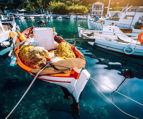 colorful-greek-fishing-boats-in-small-port-harbor-resize.jpg